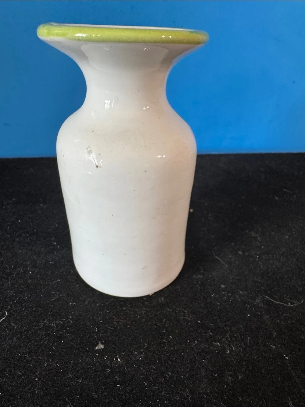 vintage ceramic vase features hand-painted floral motifs typical of mid-century